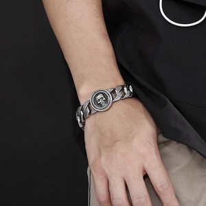 Hip hop men's stainless steel skull bracelet with vintage pattern on a model's wrist