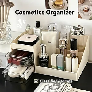 Creamy white tiered makeup organizer with transparent drawers on a vanity desk