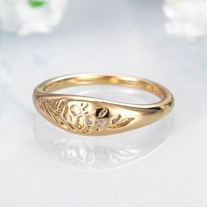 Macro view of golden ring with leaf patterns and S925 engraved silver hallmark