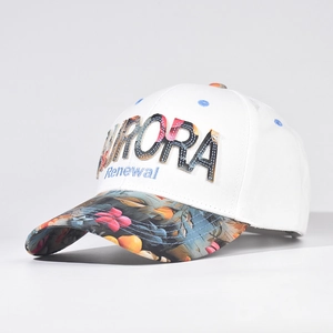 Detail of white baseball cap with colorful Aurora embroidery and floral brim pattern