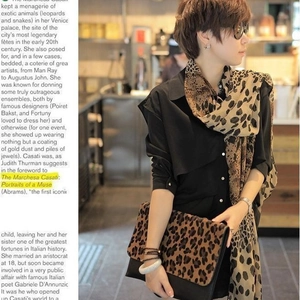 Elegant leopard print chiffon scarf and matching clutch set displayed in a cafe setting