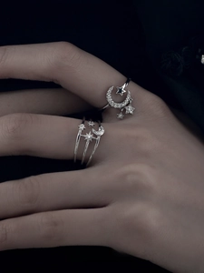 Detail of silver star and moon rings with sparkling zircon accents on hand display