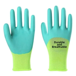 Detail of green latex coated work gloves with breathable knit cuffs and textured grip