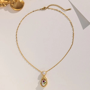 French vintage gold chain necklace with a baroque pearl pendant and purple gemstone