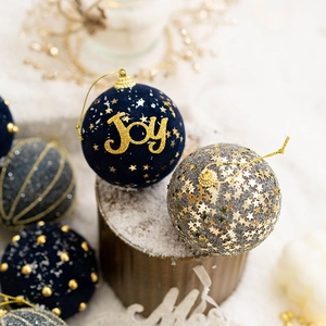 Blue velvet Christmas ball ornaments with gold Joy text and glittering star filling