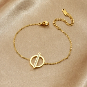 Elegant gold plated stainless steel bracelet with diamond bar and circle on champagne satin