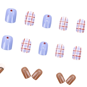 Short square press-on nails with red blue plaid patterns and glossy graffiti finish