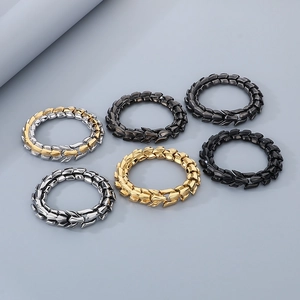 Detail of dragon bone link bracelets in gold, silver, and black polished stainless steel