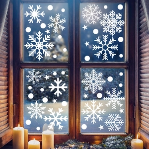 Cozy winter window scene with white snowflake static stickers on glass with candle and snow
