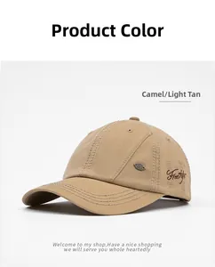 Detail of Freestyle embroidery and metal plaque on light tan cotton baseball cap