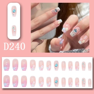 Detail of long ballerina press-on nails with D240 floral rhinestones and purple gradient