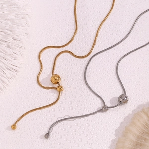 Detail of adjustable Y-shaped snake chain necklace with round beads in gold and silver