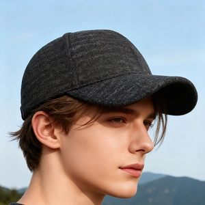 Deep grey wool baseball cap with ear flaps for winter outdoor warmth on a model