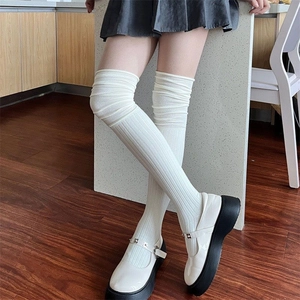 Close-up of white ribbed over-the-knee knitted socks in a stylish JK academy style