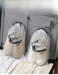 Macro shot of frosted travel shoe bags with drawstrings inside an open suitcase