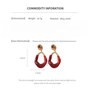 Detail showing red resin oval earrings with alloy plating, size 4.6cm by 2.3cm