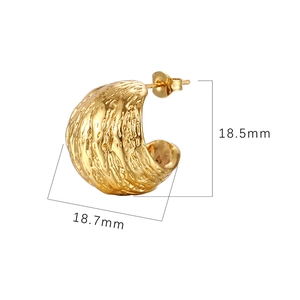 Detail of gold hollow hoop earring with organic texture and 18.5mm size dimensions