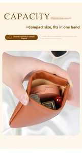 Detail view of caramel brown leather squeeze pouch showing capacity for lipstick and makeup