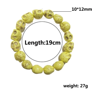 Skull bracelet with 10x12mm synthetic turquoise beads on a plain white background