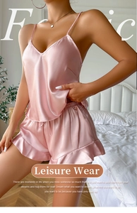 Pink silk satin pajama set featuring a deep V-neck camisole and ruffled shorts
