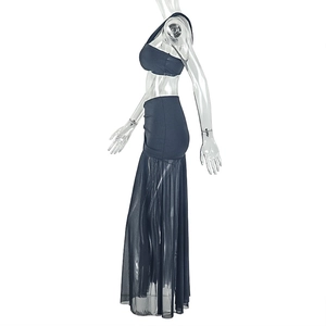 Detail of two-piece black set featuring a cropped halter top and a high-waisted mesh maxi skirt