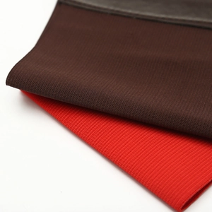 Close-up of elastic mesh fabric texture in dark brown and red for stretch waist cinchers
