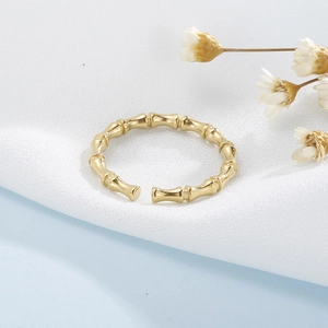 Macro detail of the golden bamboo joint design and adjustable opening on the ring