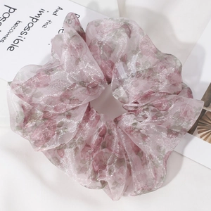 Macro detail of pink floral organza scrunchie with sheer fabric and soft shimmer texture