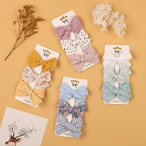 4-set bow hair clips for kids with floral, polka dot, and checkered fabric patterns