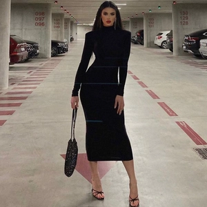 Detail of a sleek black tight-fitting long-sleeved dress with an elegant high neck collar
