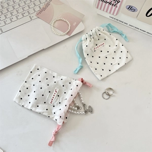 Polka dot drawstring jewelry pouch with soft cotton fabric and colored braided ropes