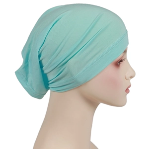 Close-up of mint green elastic hijab cap with multi-layer pleats and reinforced stitching