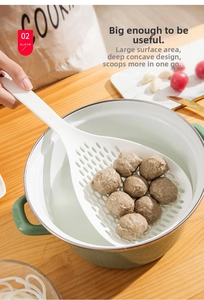 Deep white skimmer ladle draining large meatballs from a pot in a cozy kitchen setting