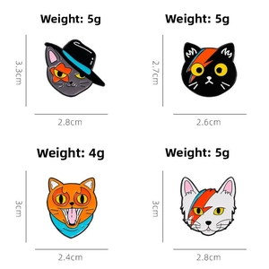 Detailed view of four colorful enamel cat pins with sizes and weights shown in cm and grams