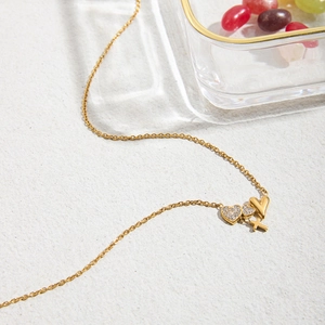 Golden 18K stainless steel necklace with diamond heart and cross pendants detail
