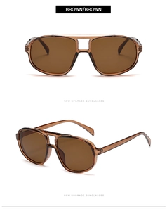 Detail view of oversized pilot sunglasses featuring amber frames and brown lenses