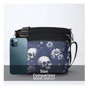 Detailed view of skull and floral print cross-body bag with triple zipper pockets
