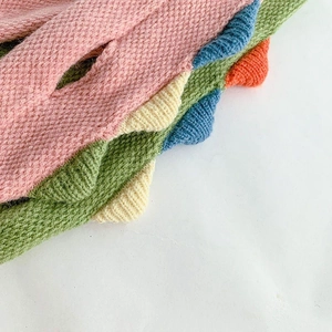 Detailed view of colorful soft knit fabric textures for children's winter scarves