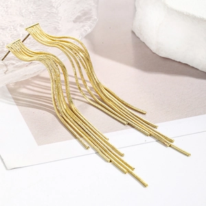 Detail view of long gold tassel earrings with multiple snake chains and rhinestone accents