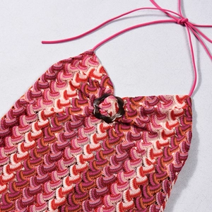 Detail of vibrant crochet halter top featuring wavy colorful patterns and central ring