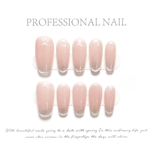 Detail of handmade nude pink gradient press-on nails with silver glitter and glossy finish
