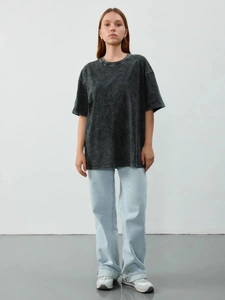 Close-up of vintage washed cotton texture and dropped shoulder seam on t-shirt