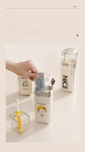 Close-up of portable travel toothbrush cup set with cartoon illustrations and transparent lid