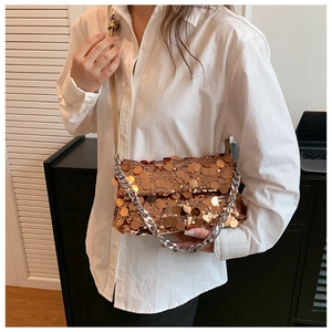 Detail of rose gold sequin handbag with silver chain strap and leather shoulder strap