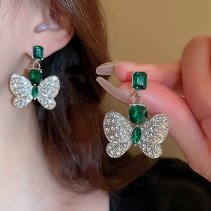 Elegant butterfly drop earrings with emerald gemstones and pavé crystal wings