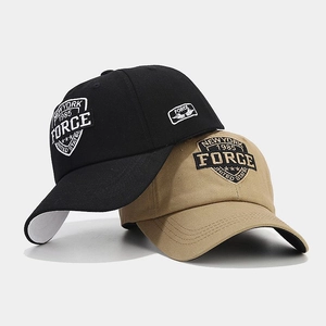 Detail of stacked cotton baseball caps in black and khaki with New York 1985 embroidery