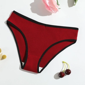 Detailed view of dark red ribbed cotton panties with black piping and cherry decoration