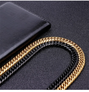 Detail of two-tone gold and silver flat curb chain necklace with metallic texture
