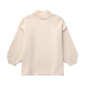 Detailed view of the off-white knit sweater texture and comfortable ribbed cuffs