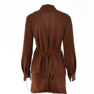 Detail of a brown long-sleeve shirt showing the glossy fabric and lace-up back design